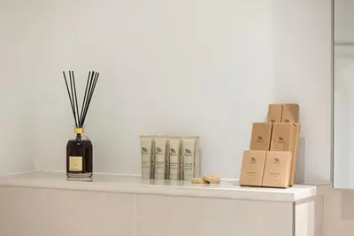a shelf with a bottle of wine and some boxes at Prime Downtown Location 2BR Walk to Dubai Mall in Dubai