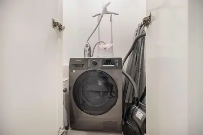 a washing machine sitting in a laundry room with at Elegant 2BR Downtown Dubai Walk to Dubai Mall in Dubai