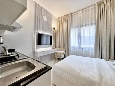 a hotel room with a bed and a sink at Signature Vista Studio Apartment in Dubai