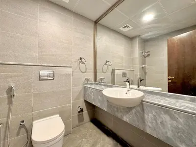 a bathroom with a sink and a toilet at Signature Vista Studio Apartment in Dubai