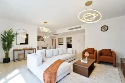 a white living room with a white couch and chairs at Elegant and Spacious 3-bedroom in JBR in Dubai