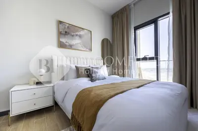 a bedroom with a white bed and a window at Bloomfields Cozy 1br In Rukan in Dubai