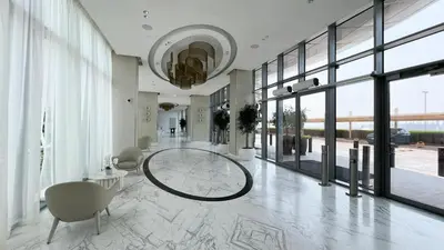 a lobby with a large room with large windows at Premium Corner 3BR, Sea Views with Sunset, 85 inch TV in Dubai