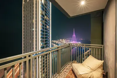 a balcony with a view of the eiffel tower at Premium Corner 3BR, Sea Views with Sunset, 85 inch TV in Dubai