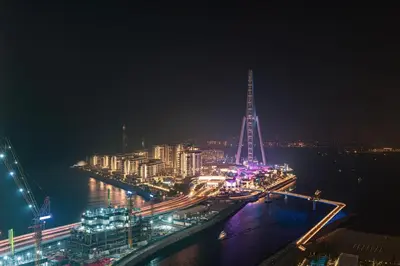 a view of a city at night with the river at Premium Corner 3BR, Sea Views with Sunset, 85 inch TV in Dubai