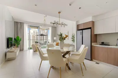 a kitchen and dining room with a table and chairs at Silkhaus Lavish 2BDR Retreat at Dubai Creek Harbour in Dubai