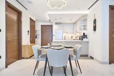 a kitchen and dining room with a table and chairs at STAY BY LATINEM Luxury 2 BR Plus Maid Holiday Home CD 0208 Near Burj Khalifa in Dubai