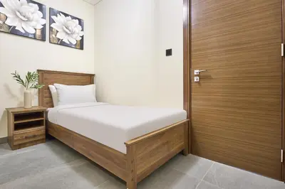 a bedroom with a bed and a wooden door at STAY BY LATINEM Luxury 2 BR Plus Maid Holiday Home CD 0208 Near Burj Khalifa in Dubai