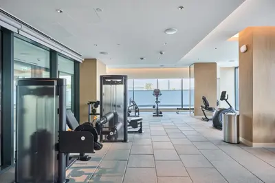 a gym with treadmills and exercise equipment in a building at STAY BY LATINEM Luxury 2 BR Plus Maid Holiday Home CD 0208 Near Burj Khalifa in Dubai