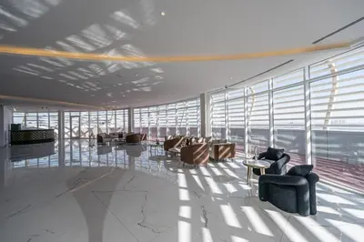 a large room with chairs and tables and windows at Bright studio oplaz by Danube Near Miracle Garden in Dubai