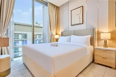a bedroom with a large white bed and a large window at STAY BY LATINEM Luxury 1BR Holiday Home CVR A3304 near Downtown in Dubai