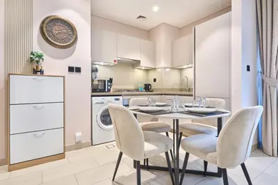 a kitchen and dining room with a table and chairs at STAY BY LATINEM Luxury 1BR Holiday Home CVR A3304 near Downtown in Dubai