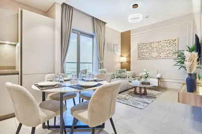 a living room with a table and chairs and a couch at STAY BY LATINEM Luxury 1BR Holiday Home CVR A3304 near Downtown in Dubai