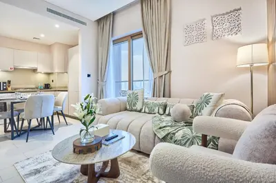 a living room with a couch and a table at STAY BY LATINEM Luxury 1BR Holiday Home CVR A3304 near Downtown in Dubai