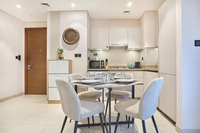 a kitchen and dining room with a table and chairs at STAY BY LATINEM Luxury 1BR Holiday Home CVR A3304 near Downtown in Dubai