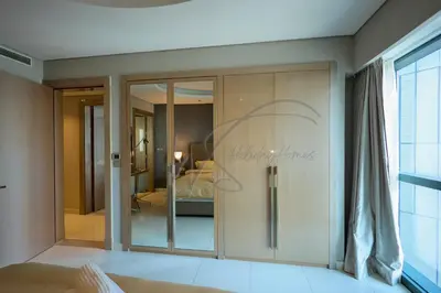 a room with a sliding glass door with a bedroom at DAMAC Paramount Towers 2BHK by WS Holiday Homes in Dubai