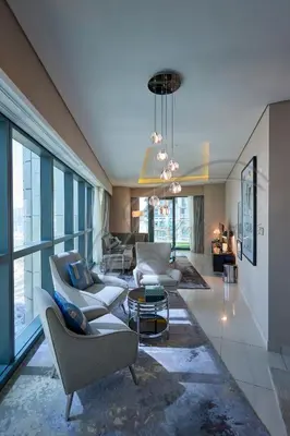 a living room with couches and chairs in a building at DAMAC Paramount Towers 2BHK by WS Holiday Homes in Dubai