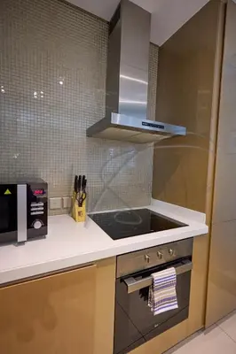 a kitchen with a stainless steel stove top oven at DAMAC Paramount Towers 2BHK by WS Holiday Homes in Dubai