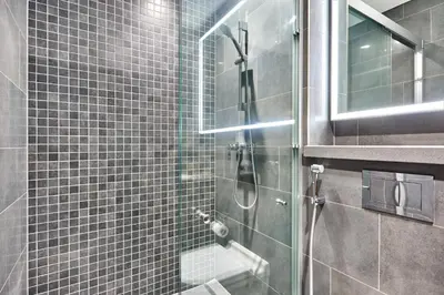 a shower with a glass door in a bathroom at STAY BY LATINEM Luxury 2BR Holiday Home CB 1215 Near Burj Khalifa in Dubai