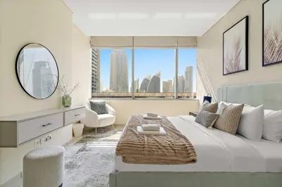 a bedroom with a large bed and a large window at Silkhaus Premium 1BDR Stay with DIFC Views in Dubai
