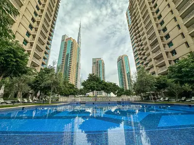 a large swimming pool in a city with tall buildings at Full Burj Khalifa and Fountain Views 2BHK Apartment by WS Holiday Homes in Dubai
