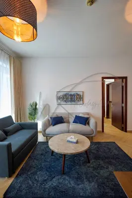 a living room with a couch and a table at Full Burj Khalifa and Fountain Views 2BHK Apartment by WS Holiday Homes in Dubai