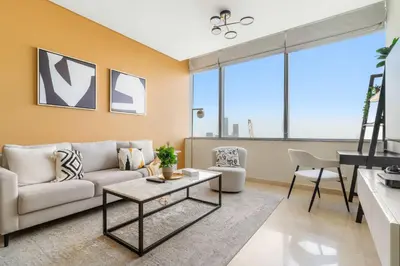 a living room with a couch and a table at Silkhaus Classic 1BDR in DIFC at Sky Gardens in Dubai