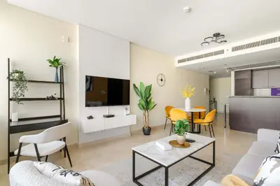 a living room with a couch and a table at Silkhaus Classic 1BDR in DIFC at Sky Gardens in Dubai