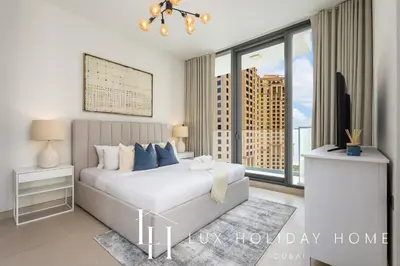 a bedroom with a bed and a large window at LUX LIV Contemporary Marina View Suite 2 in Dubai