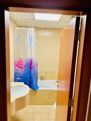 a bathroom with a sink and a shower curtain at Marina View Towers - Dubai Marina Walk Access - View - 1BHK - Marsa in Dubai