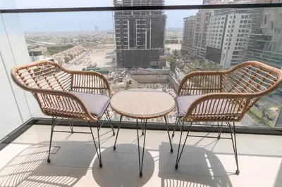 two chairs and a table on top of a window at StayShort - Perfect Studio in Binghatti Azure JVC - Sleeps 2 in Dubai