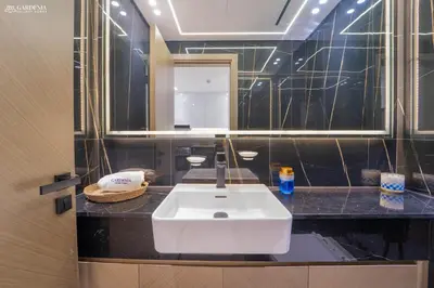 a bathroom with a white sink and a mirror at Modern Brand New 1BR Luxury Apartment With Cozy Interiors In Jumeirah Village Circle in Dubai