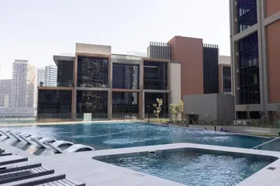 a large swimming pool in front of a building at Chic Studio Unit 1808 Peninsula Five in Sabkhah