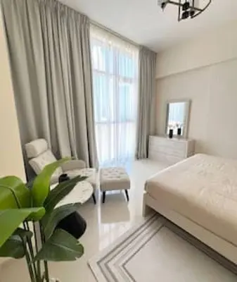 a bedroom with a bed and a chair in it at 1BR Amazing Dubai And Sea View in Dubai