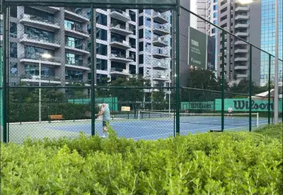 a person is playing tennis on a tennis court at Azure Palm in Dubai