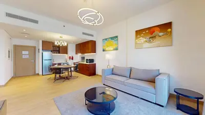 a living room with a couch and a table at Locations l Upgraded 1 Bedroom l Sea Views, Beach Access l Port de La Mer in Dubai