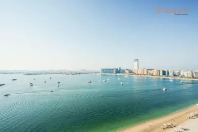 a large body of water with boats in it at Private Beach Access with Luxury Beachfront Lifestyle in Dubai