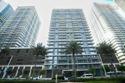 two tall buildings with palm trees in front of them at Private Beach Access with Luxury Beachfront Lifestyle in Dubai