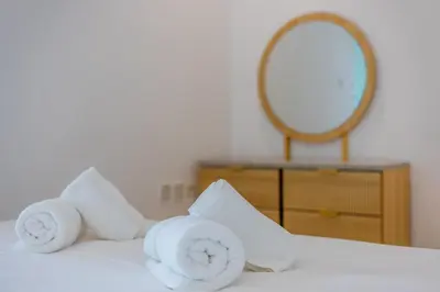 a pile of towels on a bed with a mirror at Modern Luxury Marina Stay with Ain Dubai View - Near JBR Beach in Dubai