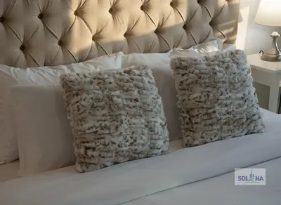 a white bed with two pillows on it at Waterfront 1BR Apartment At Heart of Dubai Marina in Dubai