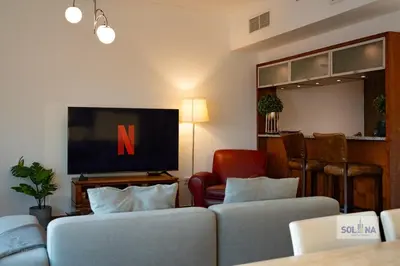 a living room with two couches and a flat screen tv at Waterfront 1BR Apartment At Heart of Dubai Marina in Dubai