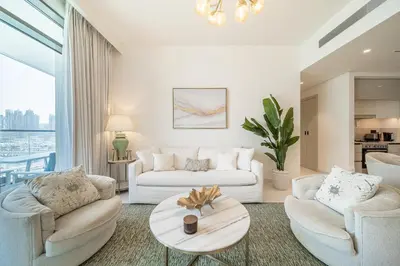 a living room with two couches and a table at Modern 2BR Retreat with Stunning Sea Views in Dubai