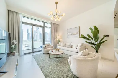 a living room with white furniture and a large window at Modern 2BR Retreat with Stunning Sea Views in Dubai