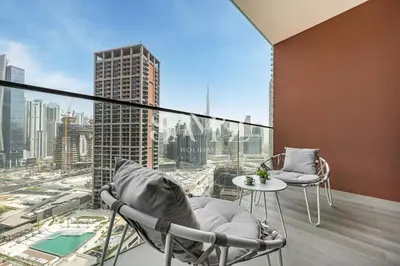 a balcony with chairs and a view of a city at Cozy Studio - Unit 1807 - Peninsula Five in Dubai