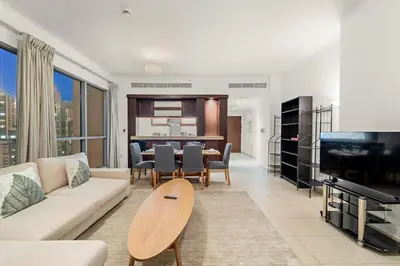 a living room with a couch and a table at FIRST CLASS 1BR Downtown Luxury in Dubai