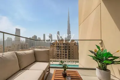 a balcony with a couch and a view of a city at Stunning 2BR- Burj Royale 411 - Burj Khalifa View in Dubai