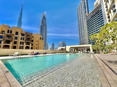 a swimming pool in a city with tall buildings at Stunning 2BR- Burj Royale 411 - Burj Khalifa View in Dubai