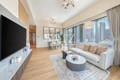 a living room with a couch and a tv at Stunning 2BR- Burj Royale 411 - Burj Khalifa View in Dubai