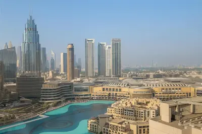 a view of a city with a river and buildings at FIRST CLASS 2BR Burj and Fountain Cozy Luxe in Dubai