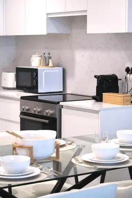 a kitchen with a table with white dishes on it at Madinat Jumeirah Living in Dubai